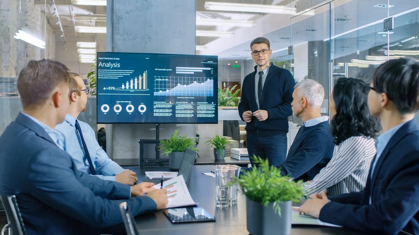 Group of people watching presentation of growth metrics